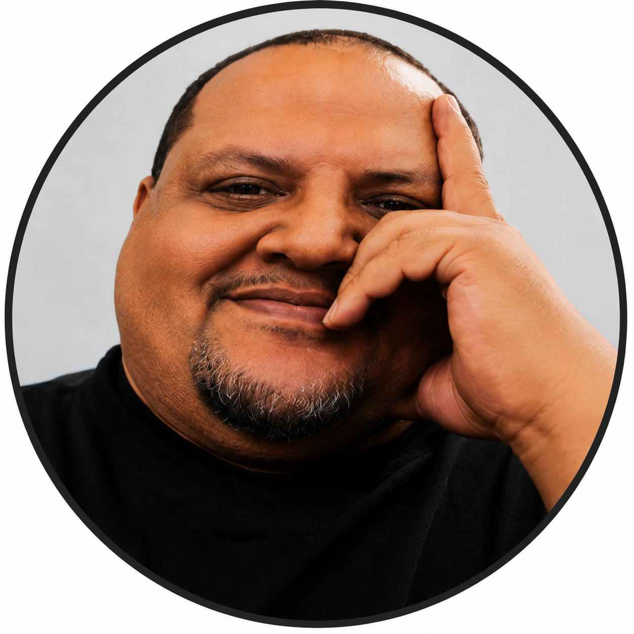 Smiling man resting face on hand