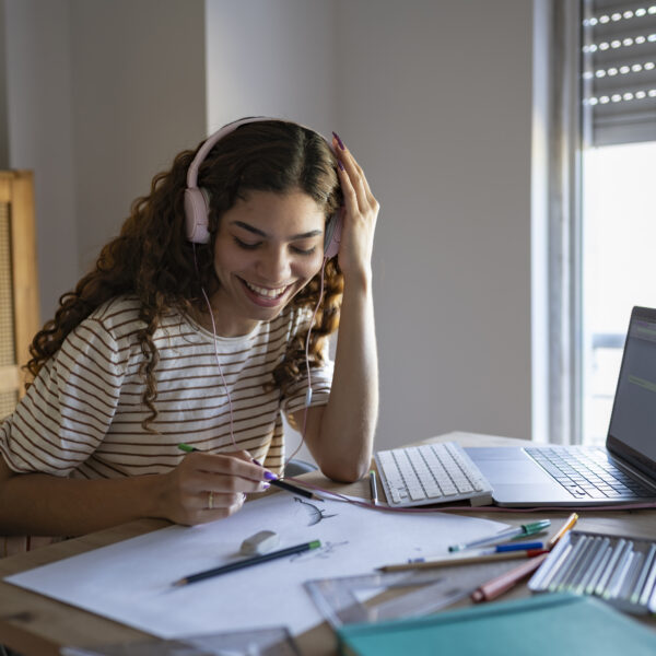 Girl drawing with headphones on
