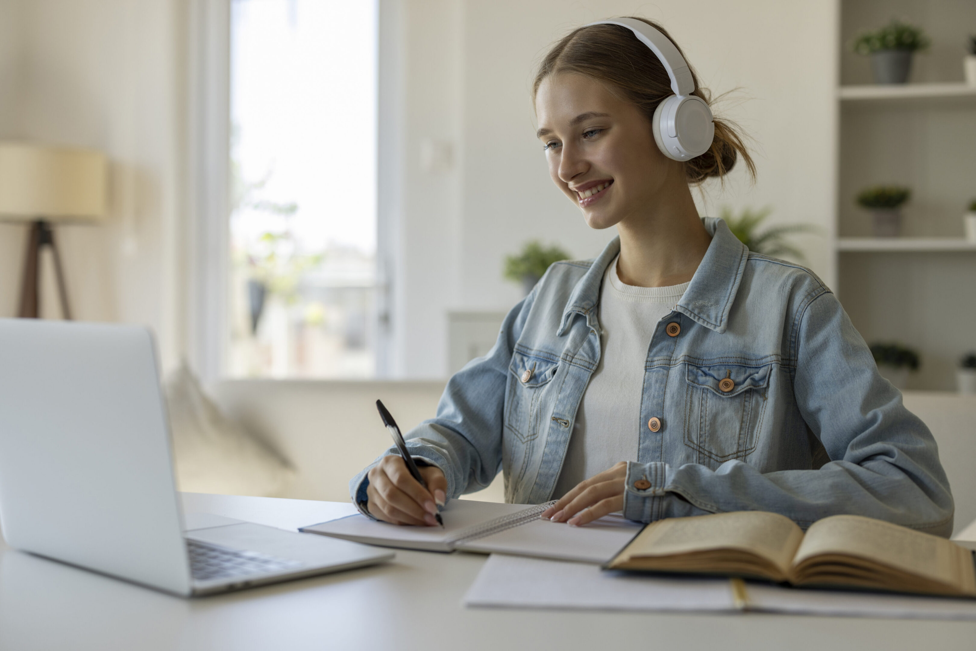 Person studying with headphones and laptop