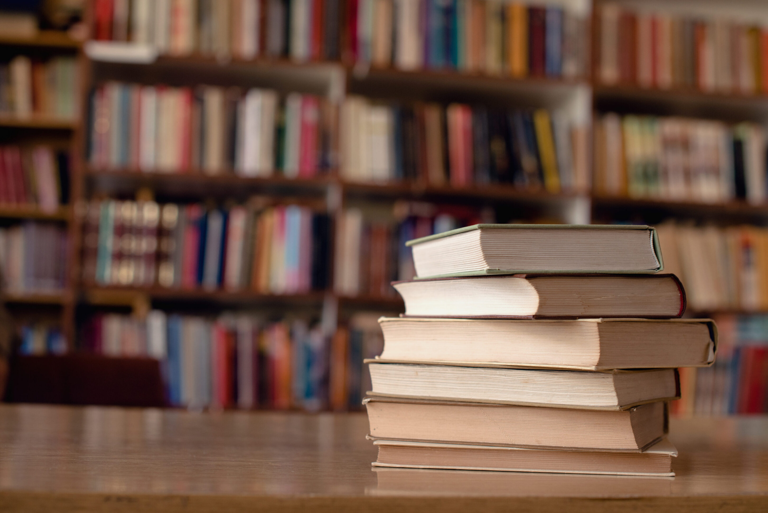 Books piled in a library setting