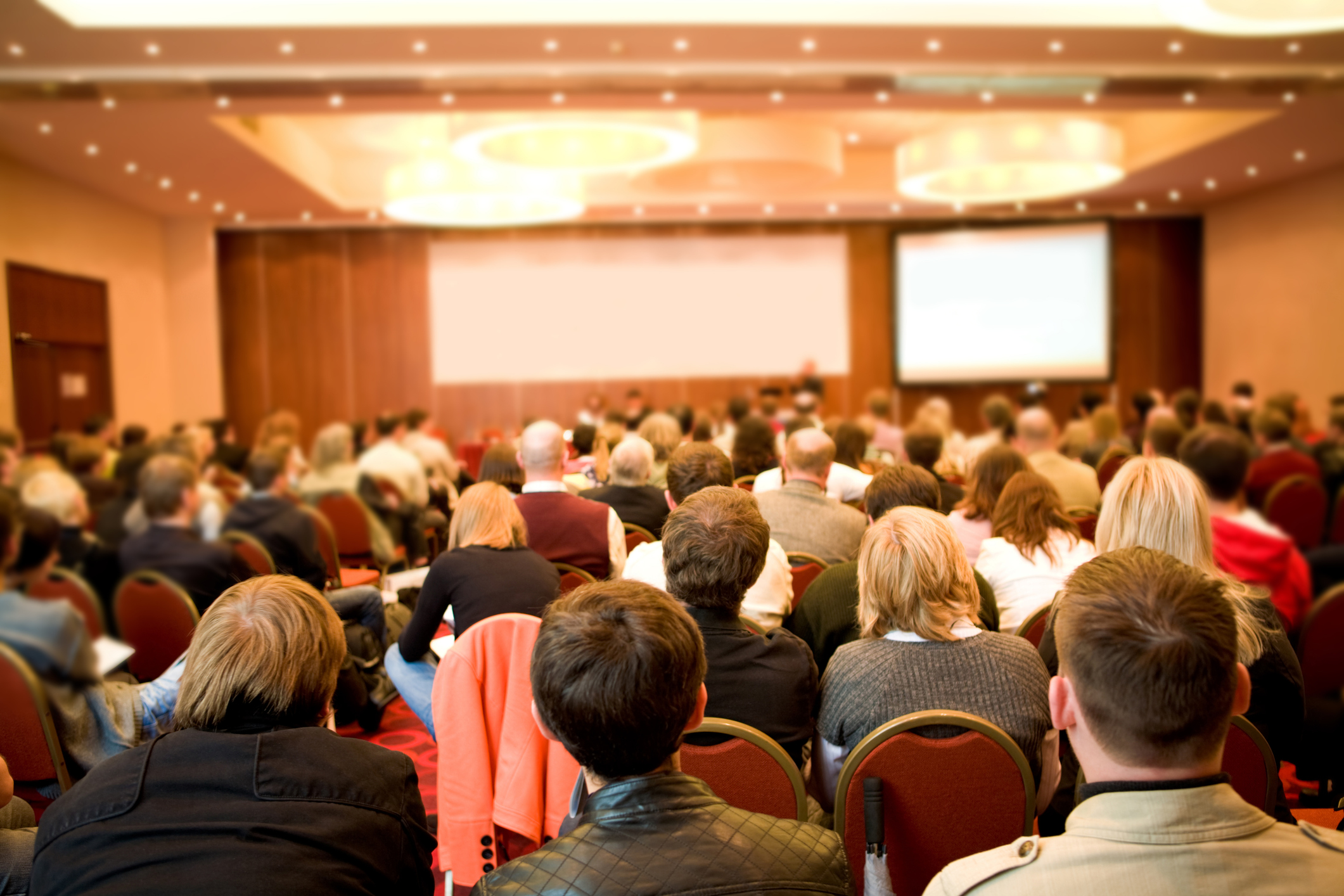 Audience seated at conference listening to presentation