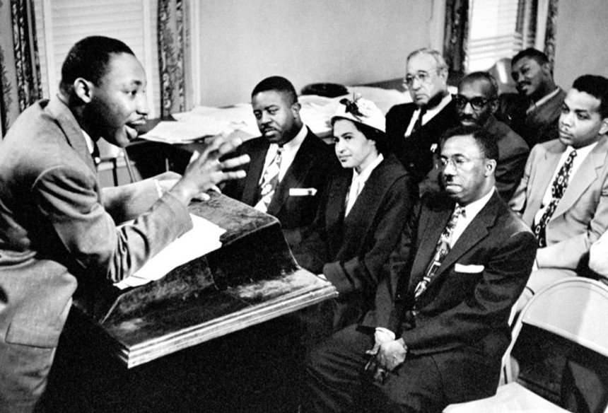 Man speaking at podium to seated audience